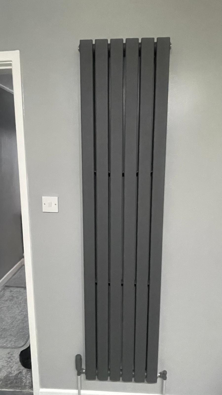 Grey vertical designer radiator fitted in hallway in Walsall
