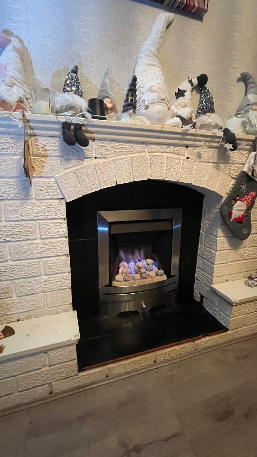 Close-up of gas fire installation with gas pipework in Dudley